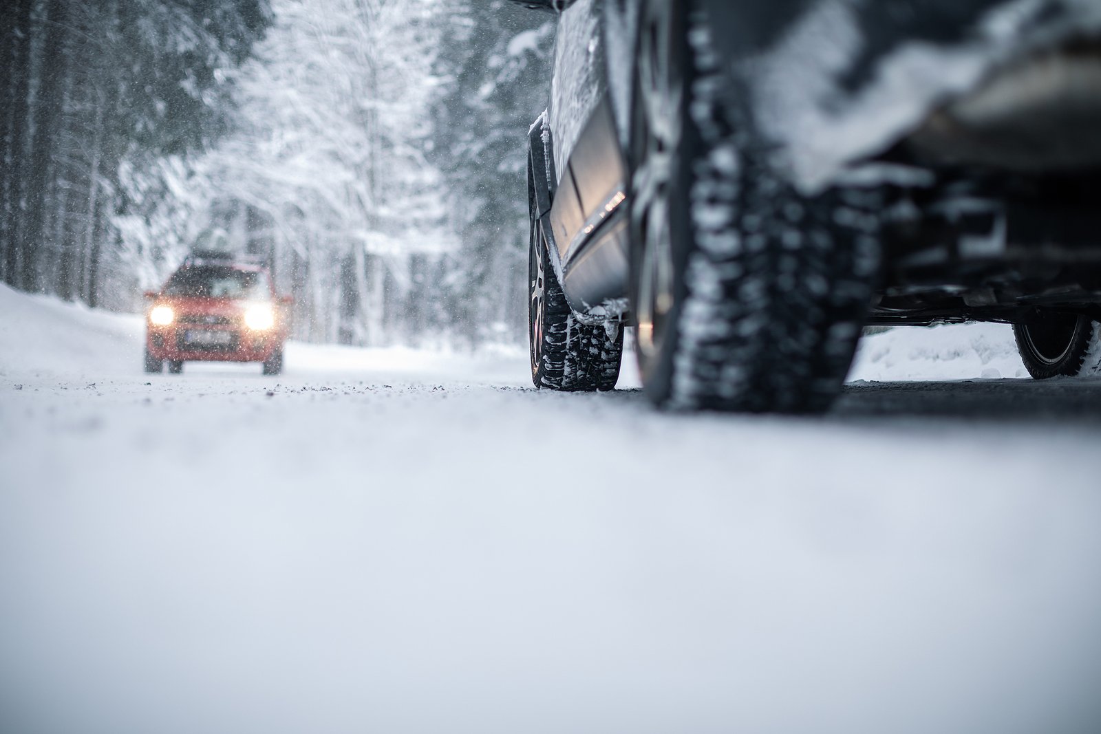 Car on a snowy winter road amid forests – using its four wheel d The All-Season European Car Checklist: Preparing Your Vehicle for New England's Weather